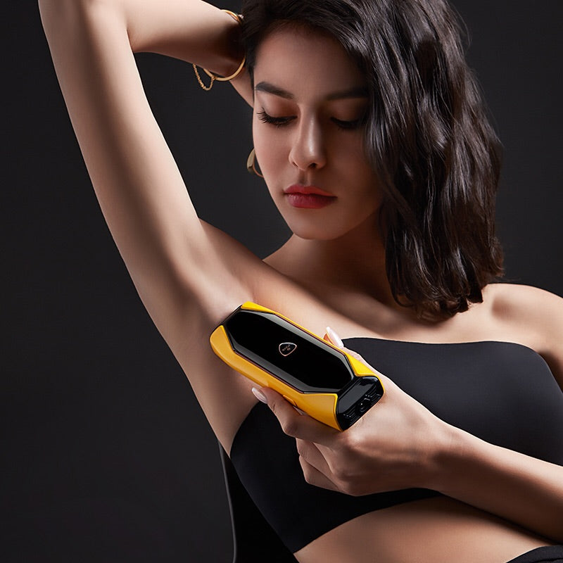 Woman using JOVS X 3 in 1 hair removal device on underarms for a smooth, hair-free appearance.